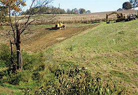 Contractors prepare to install a pond to help control excessive runoff during
storm events.