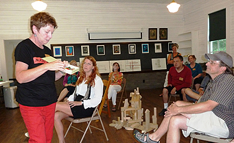 Andrew Phillips (far right), a faculty member at the 
Charter High School for Architecture and Design, listens to a 
participant in Fallingwater’s summer residency program.